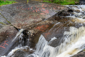 Old rock carving from the stone age by a creek in Sweden