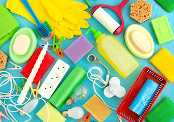 Household items on a blue background. Items for household, cleanliness, domestic comfort create a backdrop. A lot of household items in a chaotic manner.