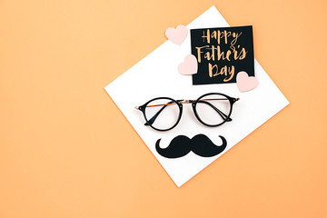 Happy fathers day concept. Top view of eyeglasses, card with phrase happy father's day and retro...