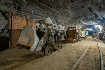 Fototapeta na wymiar Ore loading machine eimco in underground gold mine tunnel