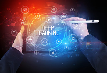 Close-up of a tablet with DEEP LEARNING inscription, innovative technology concept