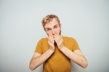 Man covering his face