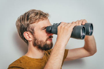 man with binoculars. gray background