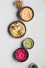 Flat-lay of Various Vegetarian dips hummus