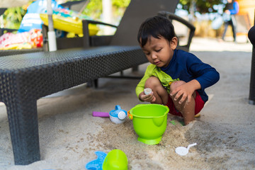 Kids playing with beach sand with they toys