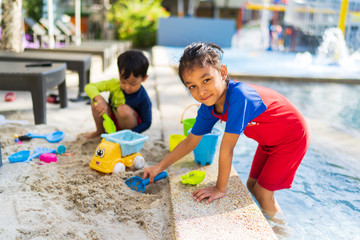 Kids playing with beach sand with they toys