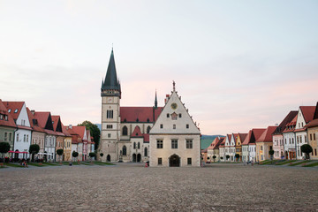 Fototapeta premium Historic town square in Bardejov, Slovakia with old historical town square with preserved bourgeois houses with colorful facades. Evening time UNESCO world heritage.
