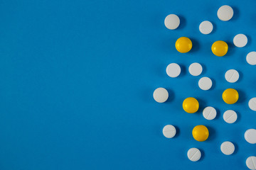 many white and red pills on a blue background
