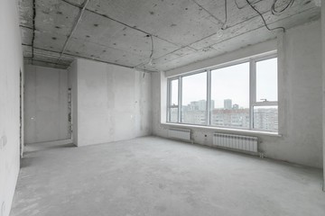 interior of a new apartment without finishing in gray tones with electrical wiring