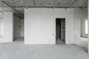 interior of a new apartment without finishing in gray tones with electrical wiring