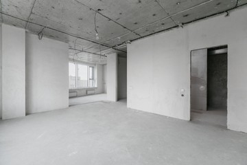 interior of a new apartment without finishing in gray tones with electrical wiring