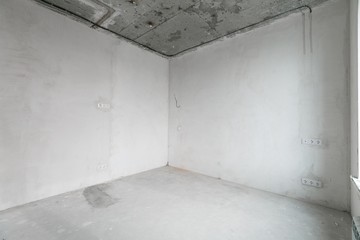 interior of a new apartment without finishing in gray tones with electrical wiring