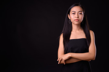 Fototapeta na wymiar Portrait of young beautiful Asian woman with arms crossed