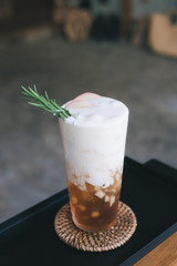 Signature apple juice with milk foam and mint leaves