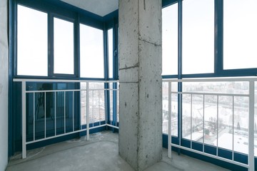 interior of a new apartment without finishing in gray tones with electrical wiring