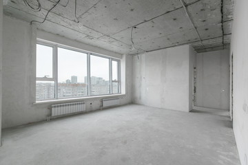 interior of a new apartment without finishing in gray tones with electrical wiring