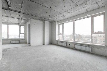 interior of a new apartment without finishing in gray tones with electrical wiring