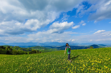 Woman in the field and blue sky clouds