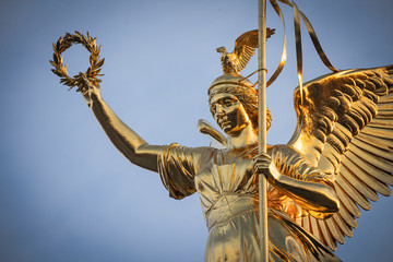 Closeup of  Berlin Center Siegessäule, Statue in golden Morning light 