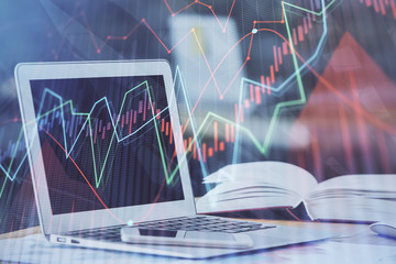 Forex graph hologram on table with computer background. Double exposure. Concept of financial markets.