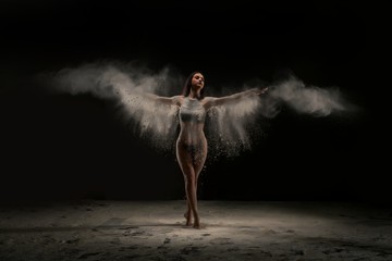 Slim woman in white dust cloud view