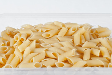 Pasta texture. Many yellow pasta are piled on the pile.