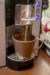 coffee machine pours a mug of cappuccino