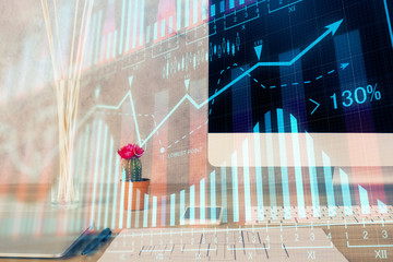 Stock market graph and table with computer background. Multi exposure. Concept of financial...