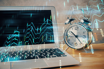 Financial graph colorful drawing and table with computer on background. Double exposure. Concept of international markets.