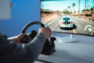 The gamer sitting at the table and gaming