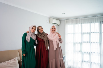 having fun while spend time three moslem women standing in bed while staying at home