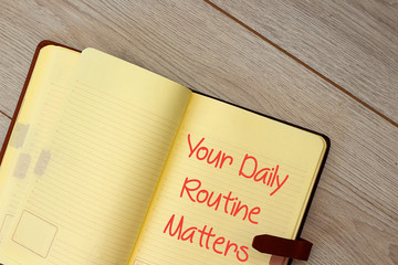Handwriting text writing Your Daily Routine Matters on notebook