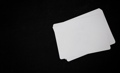 White blank paper on a black wooden office desk