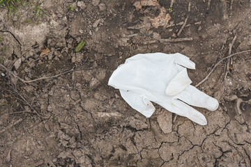 a single white protective glove on earth