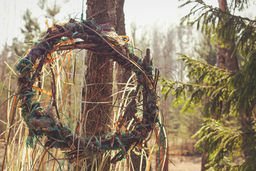 Obraz premium Pagan fantasy medieval legend sunny fresh spring summer ritual Slavic fest Kupala wreath in sunset forest park. Photo in retro hipster style processing