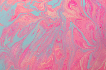 Abstract background of mixed shades of nail polish with marbled