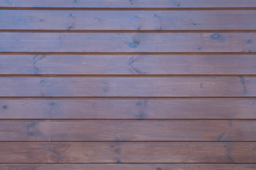 The wooden lining of the facade of the building, texture for the background.