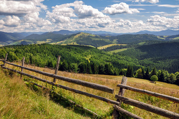Fototapeta na wymiar Beautiful sunny day is in mountain landscape. Europe, Carpathian, Ukraine..Carpathian mountains summer landscape with blue sky and clouds, natural summer background. View of mountain peaks.