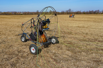 paraglider stands on the field prepared for flight