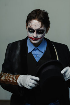 Portrait young man actor with bright makeup, role of clown posing