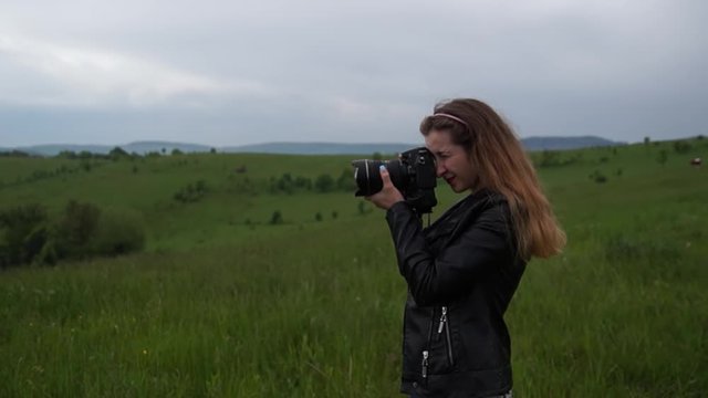 Girl photographing landscapes, early spring, around green nature