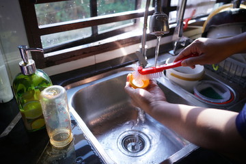 a father was washing his child's milk bottle in the morning