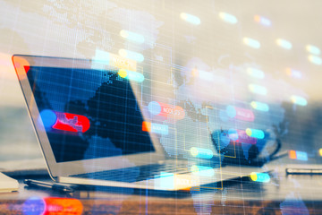Double exposure of desktop computer and technology theme hologram. Concept of software development.