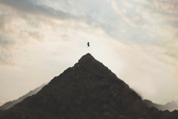 Fototapeta  jump of a woman on the peak of a mountain, concept of success obraz