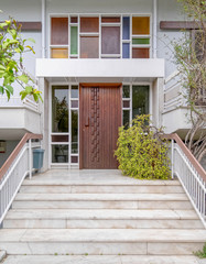 Fototapeta na wymiar contemporary house entrance stairs and natural wood door, Athens Greece