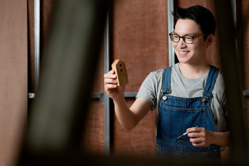 smart attractive glasses male casual costume contractor woodwork on site home renovation concept smile and confident carpenter contractor at site construction background © whyframeshot