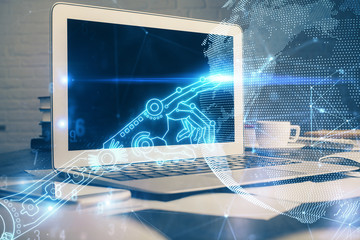 Computer on desktop in office with technology theme hologram. Multi exposure. Tech concept.