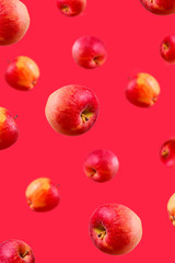 Falling large ripe red apples background. Close-up.