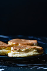 Homemade Plain Fluffy Souffle Pancake in Black Plate Ready to Eat.