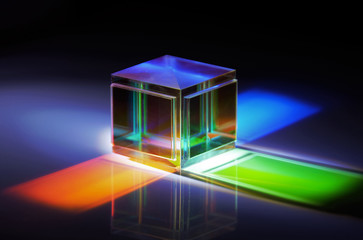 a crystal cube reflects colored rays